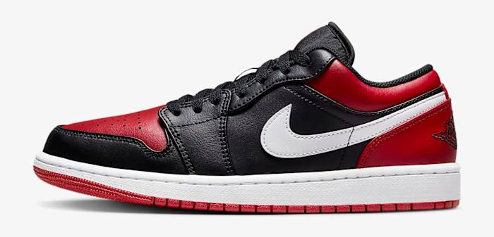 Side view of a black and red Air Jordan 1 Low sneaker.